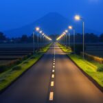 Pemkab Klaten Target Tambah 100 Titik PJU hingga Akhir 2026, 230 Titik Sudah Terpasang Ilustrasi AI jalan desa dengan lampu penerangan jalan menyala saat senja