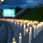 Indonesia vs Bangladesh Malam Ini Bertepatan Peringatan Tragedi Kanjuruhan, Herdman: Jika Kita Lupa, Kita Tidak Belajar Ilustrasi AI deretan lilin menyala di tribun stadion saat senja